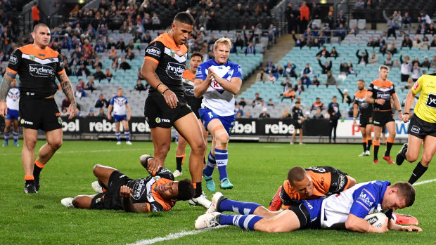 Muted effort: Kerrod Holland crosses for the Bulldogs to make for a miserable evening for the Tigers.