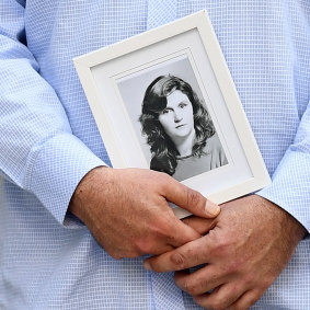 A family member holds a picture of murder victim Patricia Riggs outside the Supreme Court in Brisbane on Thursday.