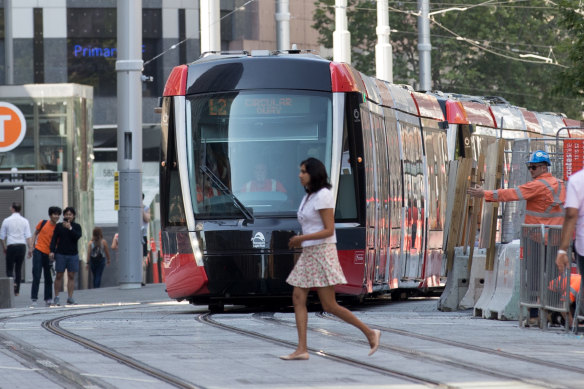 A pedestrian crosses in front of a tram on George Street last week.