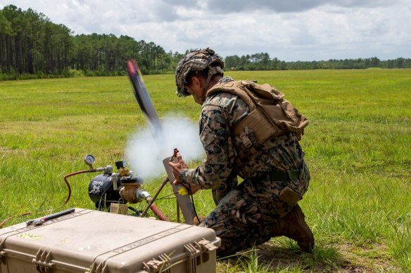 A US soldier deploys a Switchblade 300 drone. 