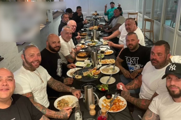 Photo from 2021 shows Toby Mitchell (second left) at a table with Sam Abdulrahim (right).