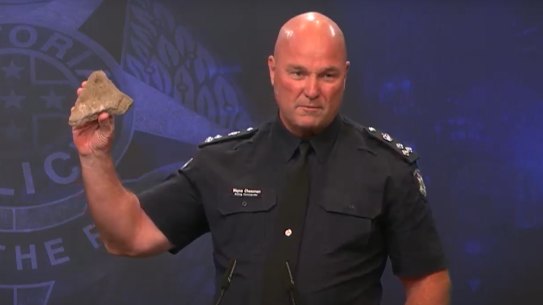 Commander Wayne Cheeseman, North West Metro region, holds up a rock.