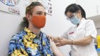 Health worker and student Max Eberle receives a booster vaccination.