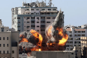 A ball of fire erupts from a building housing various international media, including The Associated Press, after an Israeli airstrike on Saturday, May 15, 2021 in Gaza City.   