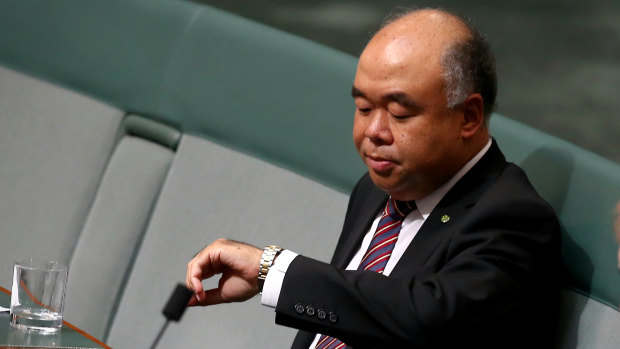 Liberal MP Ian Goodenough checks the time in parliament. Eyebrows have been raised over his off-topic LinkedIn posts.