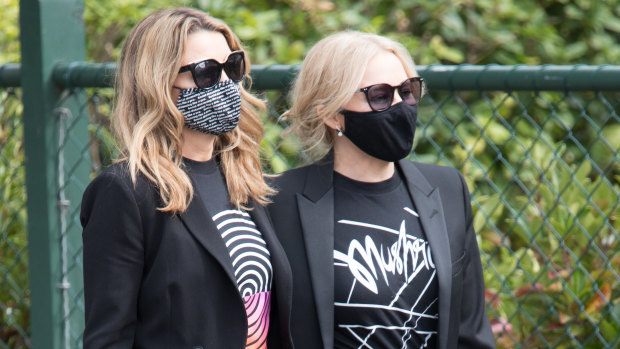 Sisters Dannii and Kylie Minogue arrive to pay their respects to the Mushroom Group founder, who was a close friend. 