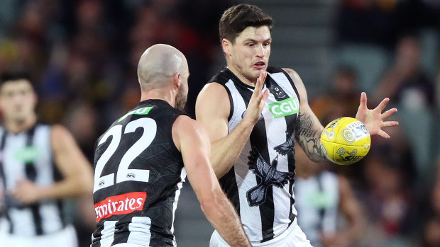 Jack Crisp receives a handball from Steele Sidebottom against the Crows at the Adelaide Oval.