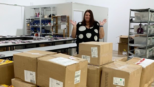 Karen Edbrooke has hardly any staff to unpack the mountain of boxes containing new stock.