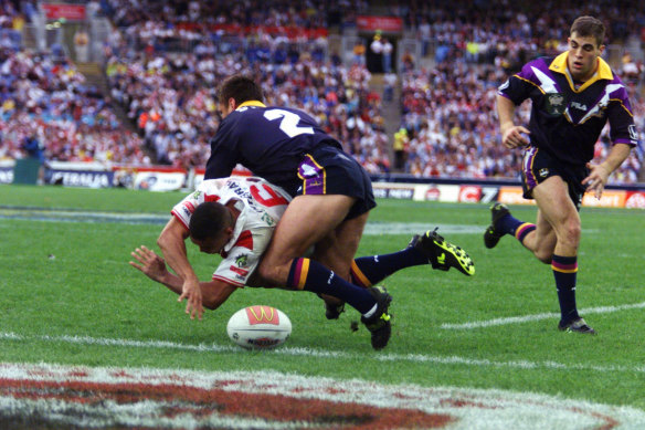 Anthony Mundine spills the ball with the try line begging under pressure from Melbourne’s Craig Smith.
