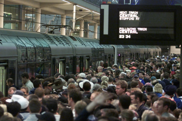 Crowds wait for trains at Olympic Park station on September 23, 2000.
