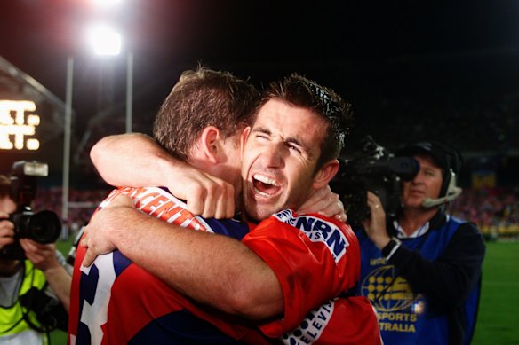 Andrew Johns and Matthew Gidley after Newcastle won the 2001 grand final. 