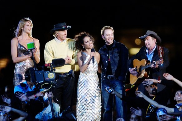 Mixed bag: Elle Macpherson, Greg Norman, Christine Anu, Savage Garden's Darren Hayes and Slim Dusty at the closing ceremony.