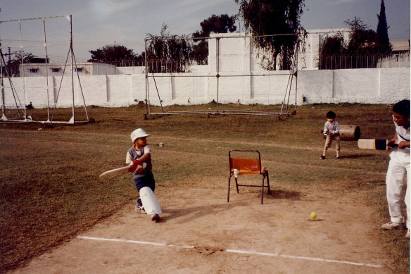 Usman Khawaja (left) as a small child playing in Pakistan, with a thigh pad covering a leg.