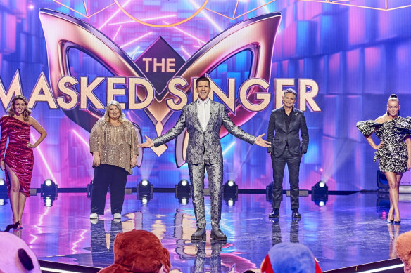 The Masked Singer's host,  Osher Gunsberg (centre), with this year's guessing panel, including Dave Hughes.
