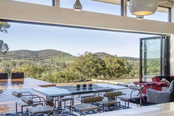 TS Valley Villa Luxury Retreat boasts a large undercover outdoor deck area with custom-built solar-heated pool, outdoor fireplace, and large sun deck overlooking the Yarra Valley and beyond.