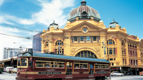 A W-Class tram saunters past Flinders St Station in Melbourne’s CBD.