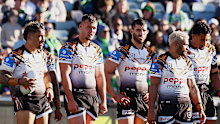 Tigers players wait for a try conversion