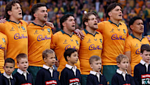 The Wallabies stand for the national anthem.