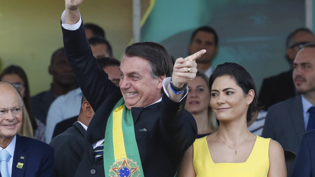 Brazil's President Jair Bolsonaro attends an Independence Day military parade accompanied by first lady Michelle Bolsonaro in Brasilia earlier this month.