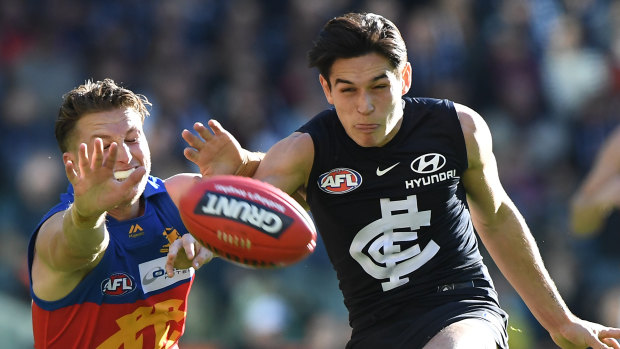 Zac Fisher of the Blues (right) and Alex Witherden of the Lions.