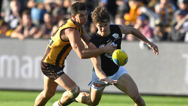 Reined in: Paddy Dow tries to escape the clutches of Hawthorn's Jaeger O'Meara.