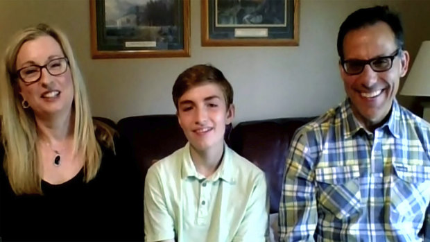 Joseph Costello, sitting between his parents Colleen and Richard, won the first the Ohio Vax-a-Million full college scholarship vaccination incentive prize. 