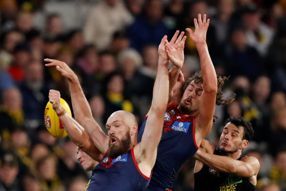 Max Gawn, Luke Jackson and Robbie Tarrant leap for the ball.