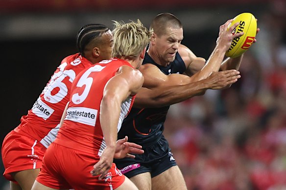 Harry Himmelberg is tackled by Joel Amartey and Isaac Heeney.