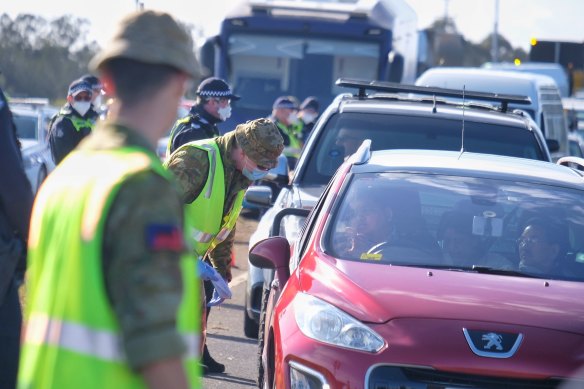 Members of the Australian Defence Force and Victoria Police at a vehicle checkpoint along the Princes Freeway near Little River to enforce metro Melbourne lockdown restrictions on Monday.