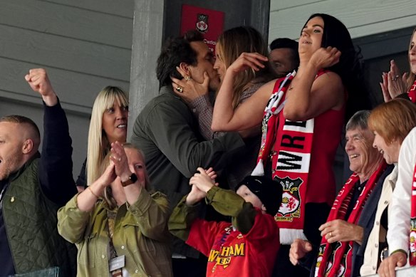Wrexham co-owner Ryan Reynolds kisses his wife Blake Lively.