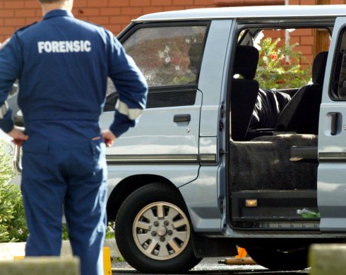 Police examine the van in which Jason Moran and Pasquale Barbaro were murdered.