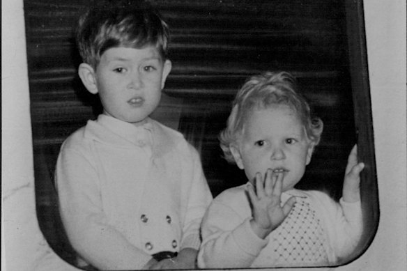 Charles and his sister, Princess Anne, wave to the crowd from the royal train at Aberdeen as they make their way to Balmoral in August 1952.