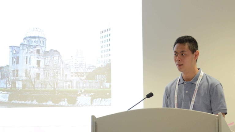 Akira Osaki from the Hiroshima branch of the Japan Down Syndrome Society tells a Glasgow audience about his involvement in a job experience program.