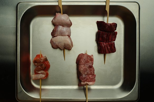 Skewers ready to be grilled, with options including chicken yakitori, ocean trout, pork, eel and wagyu.