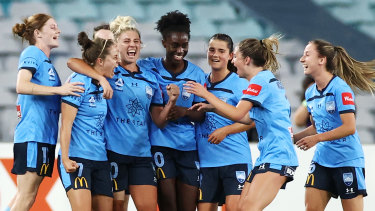 Ellie Brush celebrates a derby goal and another victory with her Sydney FC teammates.