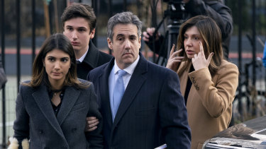 Michael Cohen arrives at a New York court on Wednesday with his wife (right) and two children. 