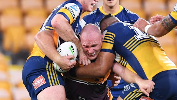 Matt Lodge of the Broncos runs into an Eels brick wall.