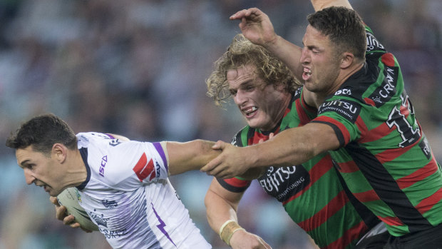 Fight night: George and Sam Burgess loom large over Billy Slater at ANZ Stadium.