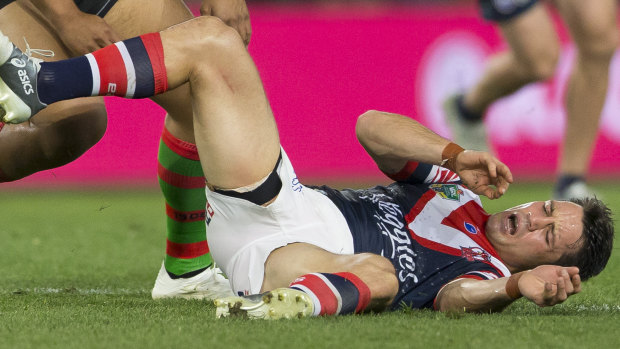 Insult to injury: Cooper Cronk goes down after being smashed in a late tackle by Tevita Tatola.