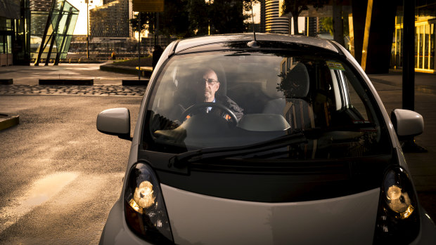 Electric car owner Daryl Budgeon in his 2012 Misubishi i-Miev, 