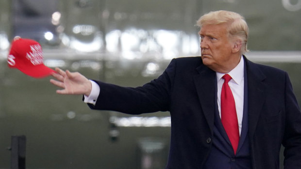 Making America Democrat again? President Donald Trump tosses baseball caps at a campaign rally in Martinsburg,  Pennsylvania, on Monday. 