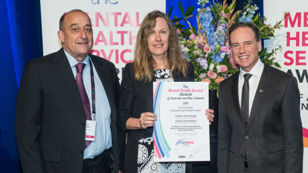 Professor Darryl Maybery and Professor Andrea Reupert are presented with an award by federal Health Minister Greg Hunt in Brisbane.
