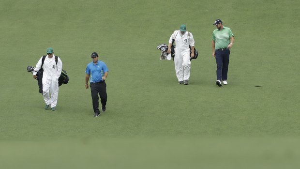 Last out: Marc Leishman, of Australia, and Patrick Reed walk down the first fairway during the third round at Augusta National.