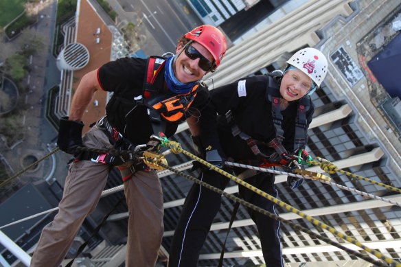 Former patient Valerie Sloss (right) abseiled off the Central Park Building in Perth in 2017 to raise money for the Fiona Wood Foundation. 