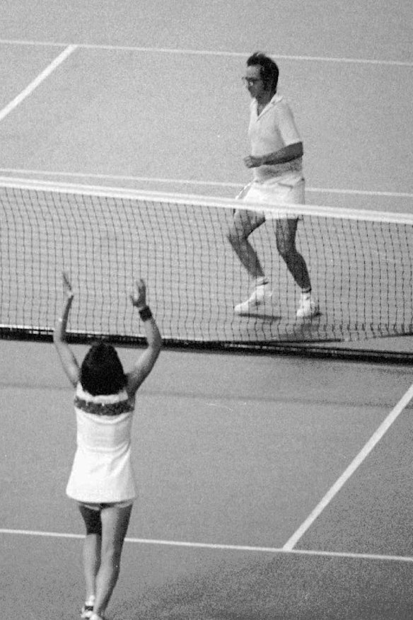 Billie Jean King raises her arms after defeating Bobby Riggs in the 1973 Battle of the Sexes. 