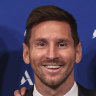 Lionel Messi poses with PSG president Nasser Al Khelaifi and sporting director Leonardo after a press conference in the French capital.