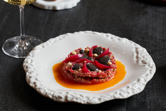 Beef rump cap tartare with black bagna cauda mayo, stracciatella, chilly oil and pickled cocktail onions.