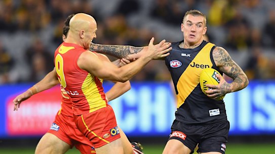 Richmond great Dustin Martin fends off Gold Coast and Geelong champion Dustin Martin.