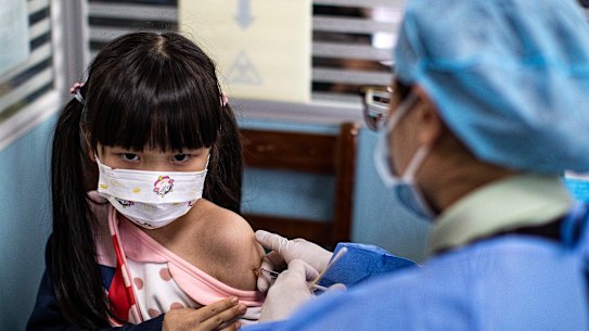 A child receives a vaccine against COVID-19 at a vaccination site on November 18, 2021 in Wuhan, China.