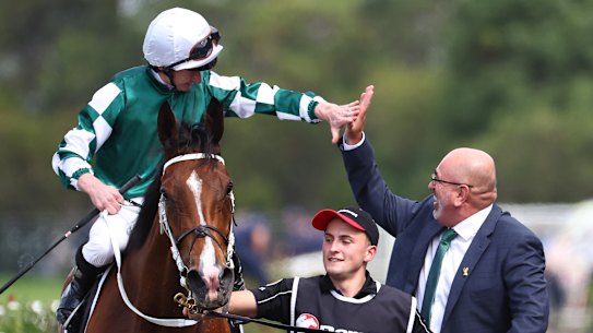 James McDonald high-fives Yulong’s Sam Fairgray as he returns on Via SIstina after the Ranvet Stakes.